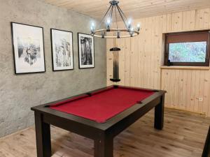 a room with a red pool table in it at Chata Stella in Mengusovce