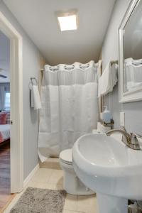 a white bathroom with a sink and a toilet at Modern and Spacious Apartment Minutes to FW and Stockyards in Fort Worth