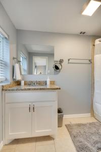 a bathroom with a sink and a mirror at Modern and Spacious Apartment Minutes to FW and Stockyards in Fort Worth