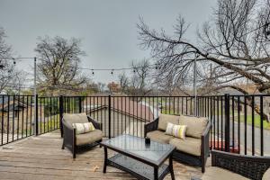 two chairs and a table on a wooden deck at Modern and Spacious Apartment Minutes to FW and Stockyards in Fort Worth