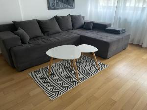 a living room with a couch and a table at Apartment IRIS in Novi Sad