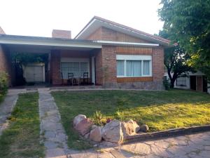 a house with a yard with rocks in front of it at Casa Monty in Mina Clavero +9 photos