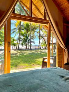 a view of the beach from the porch of a house at Hotel Oasis & Surf Camp in Santa Catalina