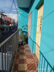 a blue building with a balcony with a door at CASA BELINDA in Santiago Atitlán