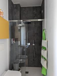 ein Bad mit einer Dusche, einem WC und einem grünen Handtuch in der Unterkunft "Beyond the Sea" Casa Vacanze - Costa dei Trabocchi in Fossacesia