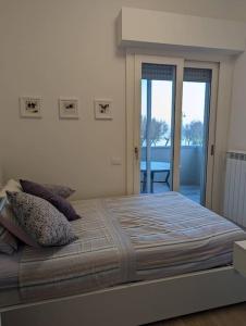 ein Schlafzimmer mit einem großen Bett und einem großen Fenster in der Unterkunft "Beyond the Sea" Casa Vacanze - Costa dei Trabocchi in Fossacesia