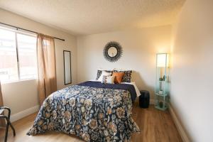 1 dormitorio con cama y espejo en la pared en Minutes to JT National Park, Hot Tub & Game Room, en Joshua Tree