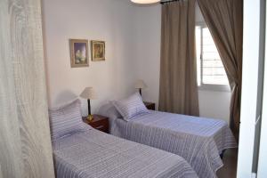 Una cama o camas en una habitación de Departamento nuevo en Condominio Portezuelo, cerca de todo