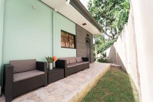 an outdoor patio with two chairs and grass at Apartment 107 in Scarborough