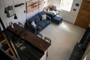 an overhead view of a living room with a blue couch at Casa de Montaña - Hunuc Huar in Potrerillos