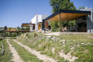 a dirt road in front of a house at Casa de Montaña - Hunuc Huar in Potrerillos