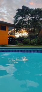 a swimming pool in front of a house at Gran Gavilán del Sarapiquí Lodge in Sarapiquí