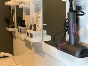 a hair dryer on a shelf in a room at SAMURISE 81INN - Vacation STAY 60983v in Fujikawaguchiko