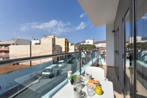 a balcony with a table and a view of a city at Apartamento Starlight La Aldea I in San Nicolás