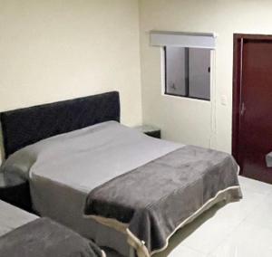 Letto o letti in una camera di España Suites Hotel