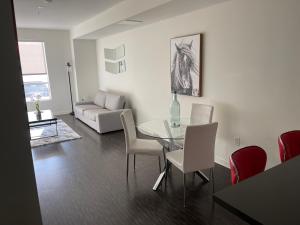 a living room with a glass table and chairs at DTLA quiet place in Los Angeles