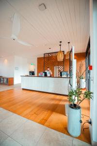 a lobby with a counter with a person in the background at Lava Hotel in Apia