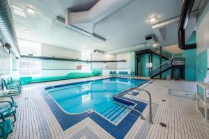 a large swimming pool in a large building at Prestige Kamloops Hotel in Kamloops