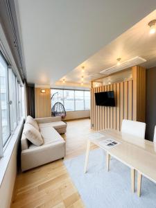 a living room with a couch and a table at Hotel Yuzuki in Takamatsu