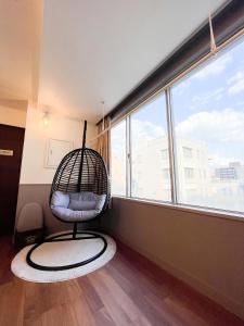 a swing in a room with a large window at Hotel Yuzuki in Takamatsu