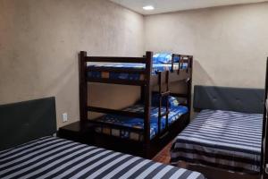 a room with two bunk beds and two twin beds at Casa de playa Tortugas Place. in Escuintla