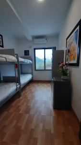 a room with two bunk beds and a wooden floor at Mountain Breath Retreat - Am Nui Tho in Yen Bai