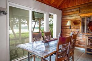 a dining room with a wooden table and chairs at Lakeside Escape in Lakehills