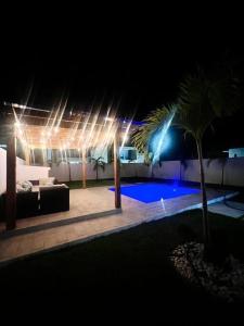 a night time picture of a swimming pool with lights at Modern Villa in Punta Cana - Villa Moderna in Punta Cana