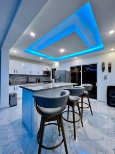 a kitchen with a blue ceiling with bar stools at Modern Villa in Punta Cana - Villa Moderna in Punta Cana