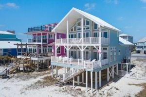 a pink and blue house on the beach at Oceanfront/Zero Steps to Beach/Views/4BR in Gulf Shores