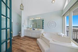 a large bathroom with a tub and a large window at Oceanfront/Zero Steps to Beach/Views/4BR in Gulf Shores