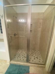 a shower with a glass door in a bathroom at Hidden Beach Oasis in Myrtle Beach +13 photos