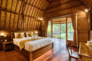 Postel nebo postele na pokoji v ubytování Puri Yalus Bungalow