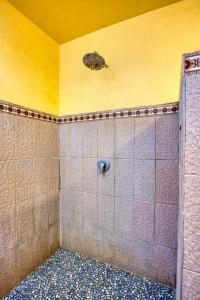 a bathroom with a shower with a turtle on the wall at Puri Yalus Bungalow in Nusa Penida