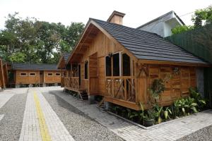 a row of wooden cabins in a building at Urbanview Villa Kolopaking Kebumen by RedDoorz in Kebumen