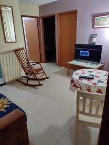 a room with two chairs and a table and a desk at Ap Estacio in Rio de Janeiro