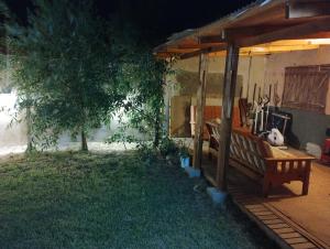 a porch with a bench in a yard at Casa En Gregores in Gobernador Gregores