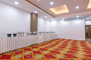 a large room with a row of tables in a room at Hotel The Luxem - Behind Ibis Hotel Gurugram in Gurgaon