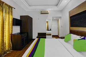 a hotel room with a bed and a television at Treebo Trend Elmas Boutique in Bangalore