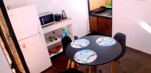 y cocina pequeña con mesa y sillas y nevera. en Alojamiento CBA - B en Córdoba