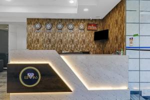 a lobby with clocks on the wall in an office at Treebo Trend Elmas Boutique in Bangalore