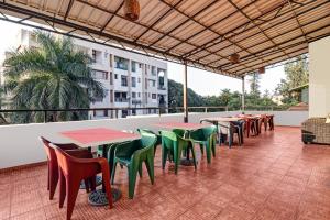 a row of tables and chairs on a patio at Treebo Trend Elmas Boutique in Bangalore