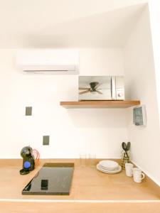 a kitchen with a laptop on a wooden counter at Balam Suites in Playa del Carmen