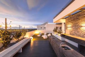 a balcony of a house with benches and a brick wall at Imperio Professional Suite by IMPERIO HAFFA in Alor Setar