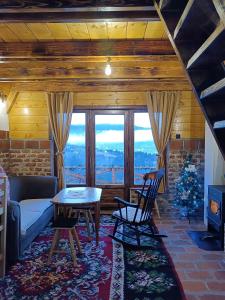 a living room with a couch and a table at Vikendica Tromedja Pale in Pale