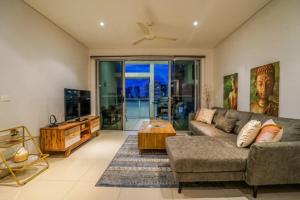 a living room with a couch and a table at ZEN CENTRAL Ambient 3BR Apt in the Heart of Darwin in Darwin