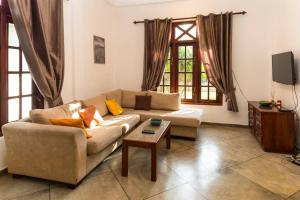 a living room with a couch and a coffee table at Villa Manali in Hikkaduwa