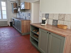 a kitchen with a counter with a coffee maker on it at Gîte des Frangines in Beaumont +6 photos
