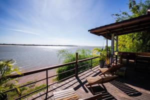 a deck with benches and a view of the water at Nakorn River View in Champasak