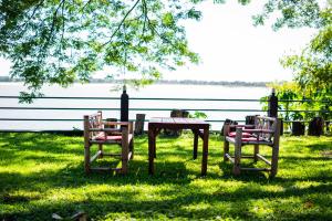 a table and two chairs and a table with a table and a table and chairs at Nakorn River View in Champasak